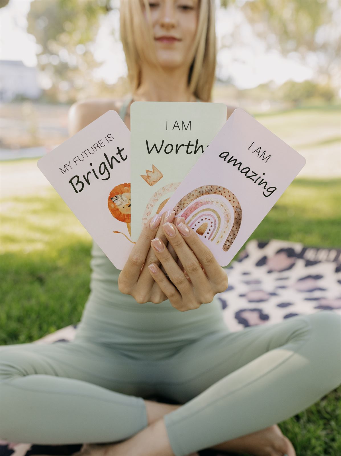 Teacher holding colorful affirmation cards